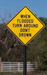 Flash flood sign says When Flooded Turn Around Do Not Drown 