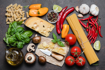 Wall Mural - Italian food cooking ingredients on dark background.