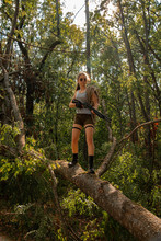 Girl With A Shotgun In The Forest