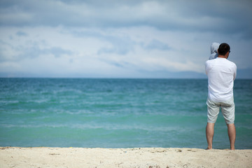 Wall Mural - man holding the baby on the beach