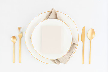 Wall Mural - Festive christmas, wedding, birthday table setting with golden cutlery and porcelain plate