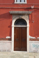 Poster - old wooden door in a stone wall