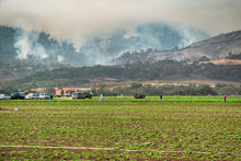The California "River Fire" In Rages Through The Hills Of Salinas, In Monterey County, With Workers In The Agricultural Fields Below. 