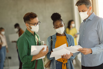 Poster - University professor and two students wearing face masks while communicating in a hallway.