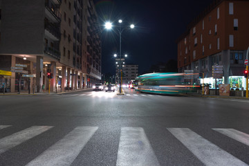 Timelapse view of traffic at an urban night intersection. Urban movement in the Italian city in the evening.