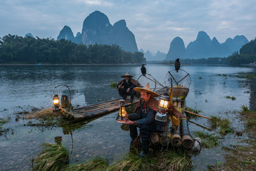 Chinese traditional living habits, images of traveling in Guilin, China, two fishermen relaxing on the Li River.