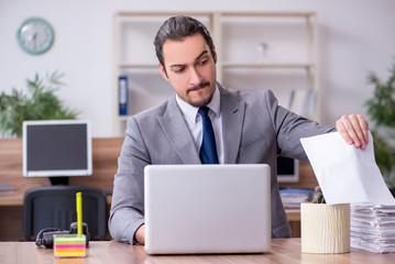 Young male employee working in the office