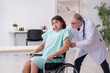 © Elnur - Young male patient in wheel-chair and experienced doctor traumatologist