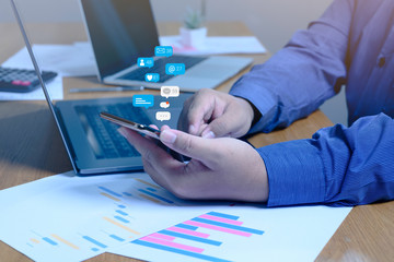 Person hand using a smartphone with social media marketing concept.