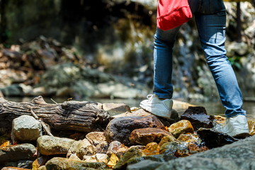 hiking travel lifestyle concept adventure,cross the stream.