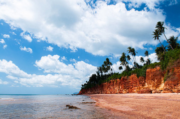Wall Mural - Tropical island red cliff  rock beach with blue sky and clouds in summer, tranquil serene ocean scenery. Fang Daeng in Prachuap Khiri Khan. Thailand