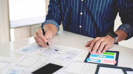 ux designer creative planning application development near layouts of mobile smartphone frameworks, User experience concept.