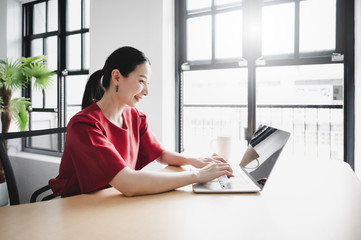 Work at home, Video conference, Online meeting video call, Portrait of beautiful young asian woman looking at computer screen watching webinar and working on laptop in workplace