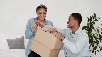 Wall Mural - A couple is packing the staff. They are moving and wrapping the boxes.