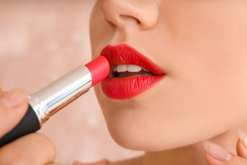 Poster - Beautiful young woman with bright lipstick on color background, closeup