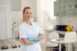 © Dusan Petkovic - Attractive blond smiling female lab assistant standing in laboratory with hands crossed and looking at camera.