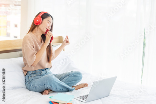 Relax woman holding book read on bed using headphone listen music. Young woman relaxation reading open book leisure mind. Happiness beautiful woman person