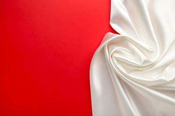 White satin fabric on red background withcopy space