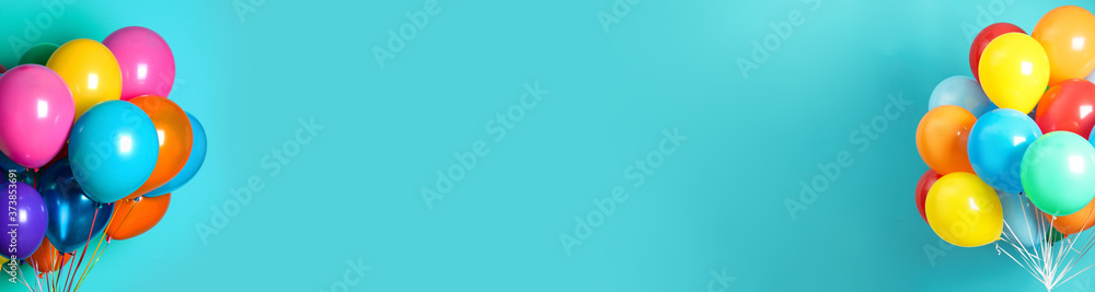 Bunches of bright balloons on light blue background, space for text. Banner design - obrazy, fototapety, plakaty 