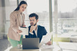 © deagreez - Portrait of two nice attractive stylish serious focused busy people ceo boss chief secretary assistant reviewing cv resume recruiting hiring talent at light white workplace workstation indoors