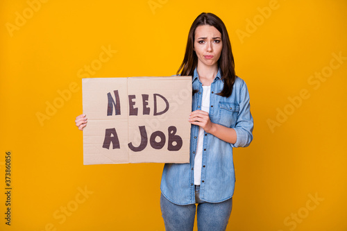 Photo of attractive beautiful young sad unemployed lady bad mood hold carton placard jobless seek job work crisis crash wear casual denim shirt isolated bright yellow color background