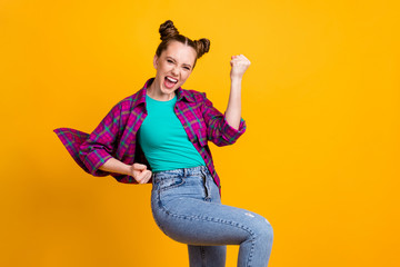 Canvas Print - Photo of attractive excited crazy teen lady two funny buns good mood cheering football team sports supporter raise fists wear casual plaid shirt isolated yellow bright color background