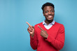 © Viktor Koldunov - Amazed african man student pointing finger aside at copy space