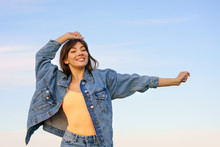 Girl In Denim Jacket And Jeans Posing Against The Sky
