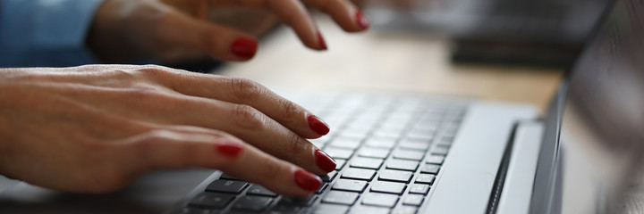 Wall Mural - Woman with red nails is typing on keyboard. Online learning professions concept