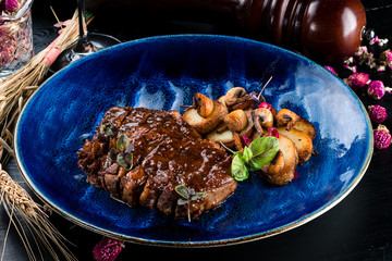 Wall Mural - Grilled Striploin Angus Steak cut on a blue plate