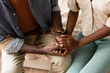 © LIGHTFIELD STUDIOS - partial view of african american couple in casual clothes holding hands at home