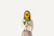 Beautiful young woman in linen dress holding sunflowers bouquet on white background. Autumn concept.