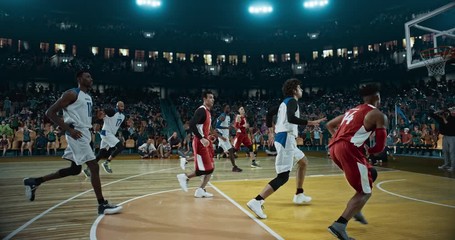 basketball player scores a goal on a professional basketball stadium. stadium is made in 3d with ani