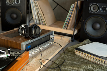 HiFi system with turntable, amplifier, headphones and lp vinyl records in a listening room