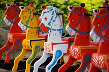 A Row Of Colourful Wooden Rocking Horse On Display Outside The Store On Mysore Road