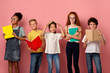 © Prostock-studio - School education. Portrait of smiling diverse kids with books and copybooks looking at camera, pink background