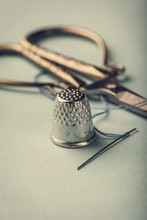 Vintage Silver Metal Thimble And Needle, Scissors On Blue Background