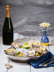 Wall Mural - Metallic bowl with fresh oysters ice lemon