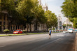 Street with a man on skateboard and Architecture of Madrid in Spain in autumn, September