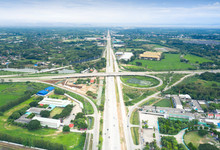 Aerial View Of Highway Road Of Chiang Mai-Lampang Province Of Thailand And Vehicle On Road.