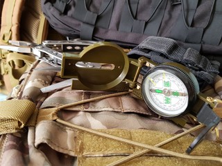 compass and multitool are in a tactical backpack