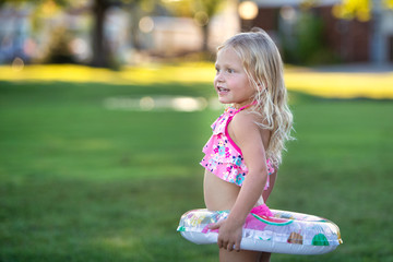 Little girl with inflatable tube.