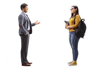 Full length profile shot of a female student and a man standing and talking