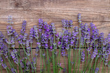 Fototapeta Lawenda - Lavender flowers on a wooden background.