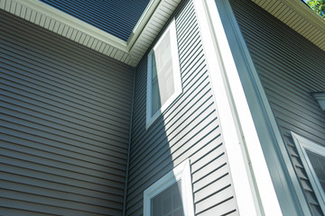 New vinyl siding and window treatments at a residential home.