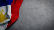 © HTGanzo - Flag of the Philippines on concrete backdrop. Filipino flag background with copy space