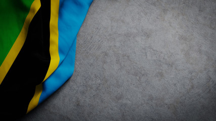 Wall Mural - Flag of Tanzania on concrete backdrop. Tanzanian flag background with copy space