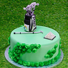 Designed birthday cake on a green grass background, Golf theme