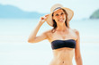 © Iurii - Girl wearing bikini and hat at the sandy beach