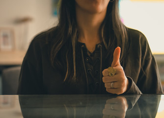 Caucasian woman gesturing with her hands on the table, explaining with her hands